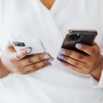 Person comparing smartphones side by side