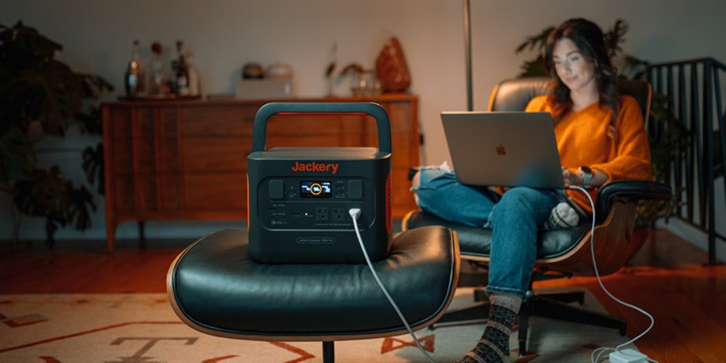 a person using a laptop computer sitting on top of a chair