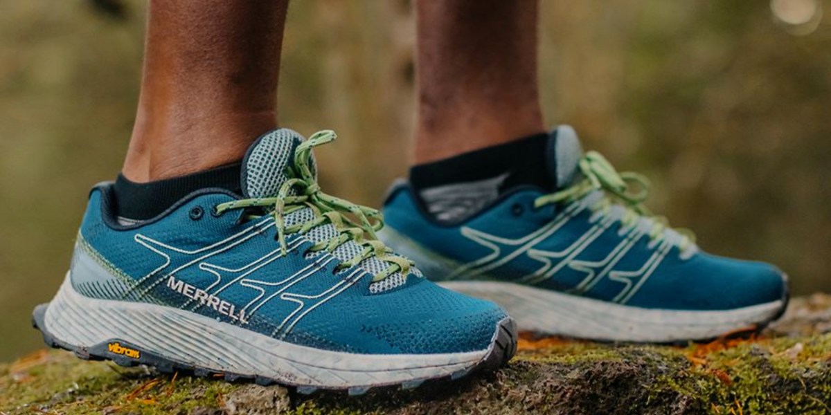 a close up of feet wearing blue shoes