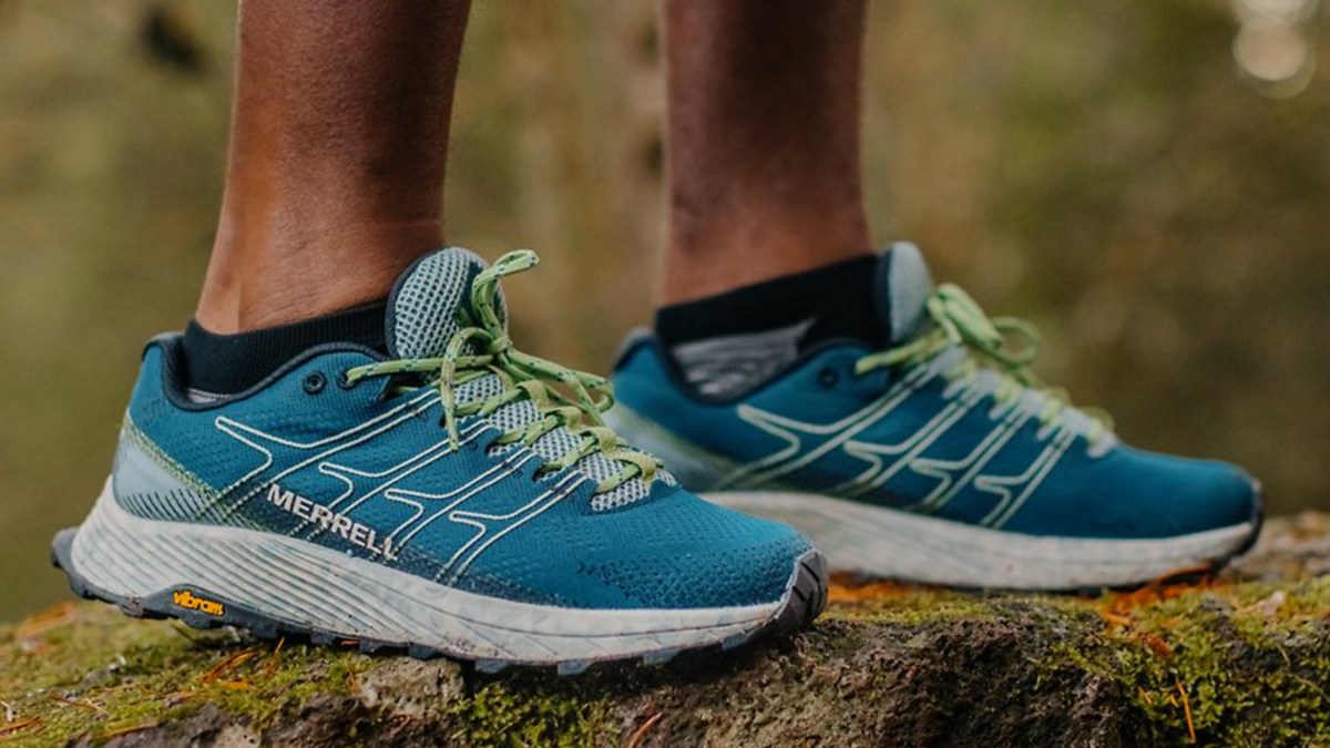 a close up of feet wearing blue shoes