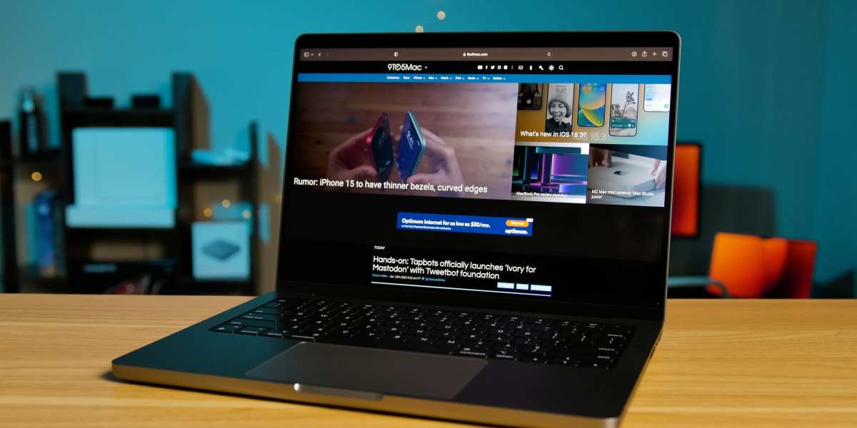 a laptop computer sitting on top of a wooden table