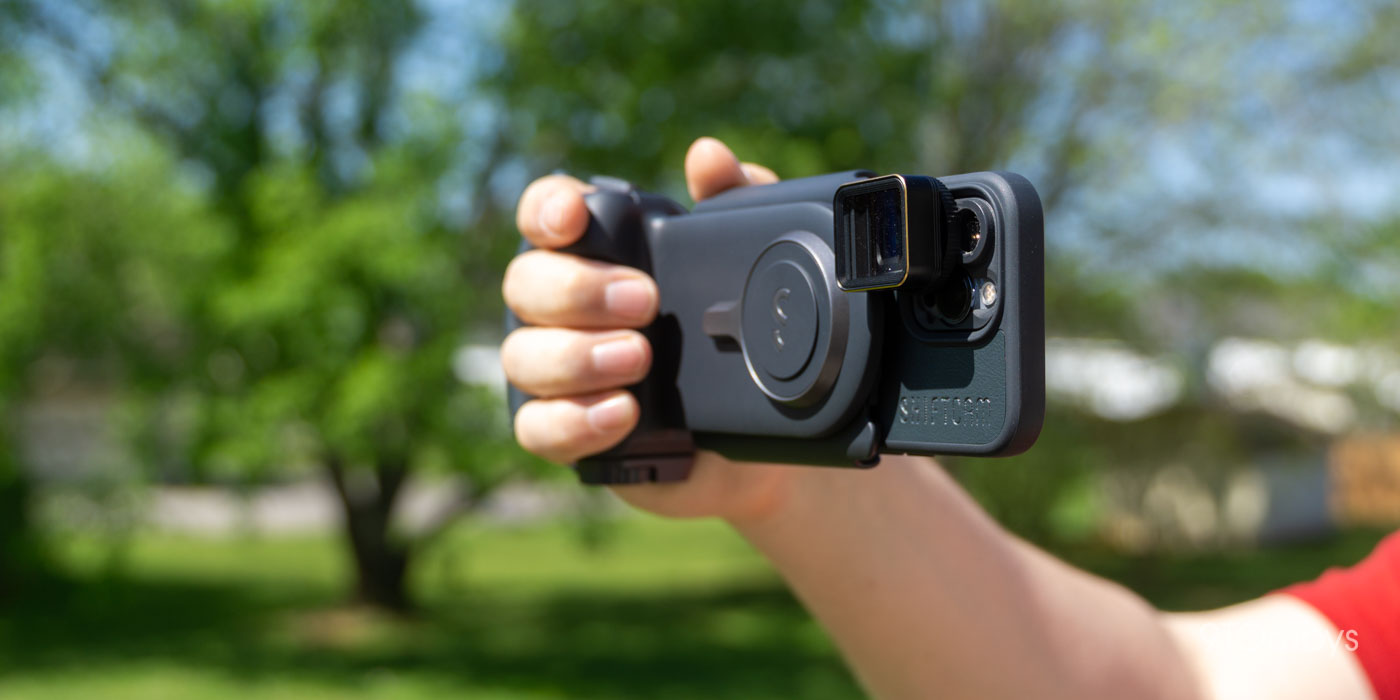 a hand holding a camera