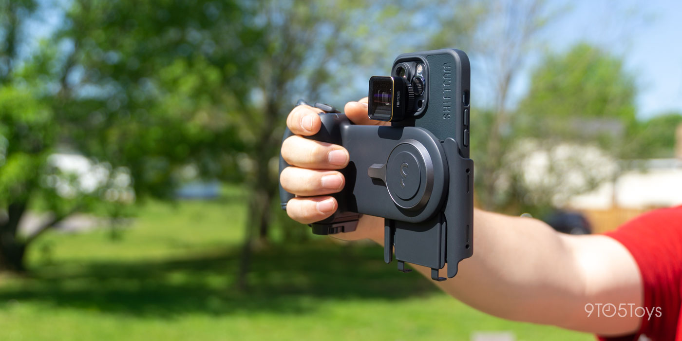 a hand holding a camera