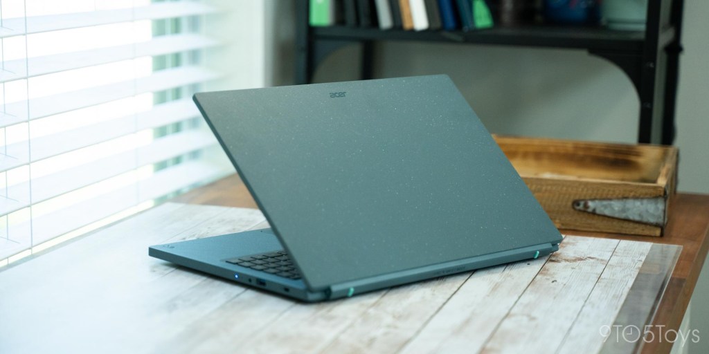 a laptop computer sitting on top of a wooden table