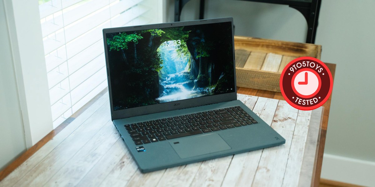 an open laptop computer sitting on top of a wooden table