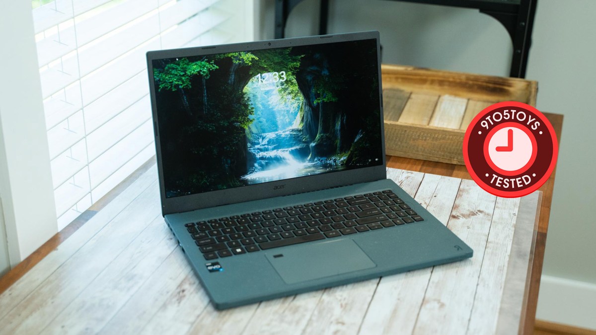 an open laptop computer sitting on top of a wooden table