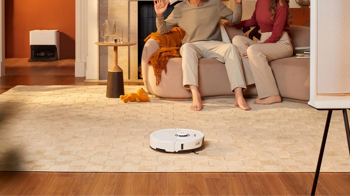 a person sitting in a living room with a wooden floor