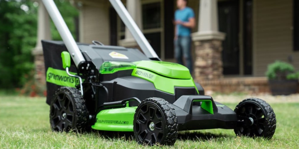 a green motorcycle parked on the grass