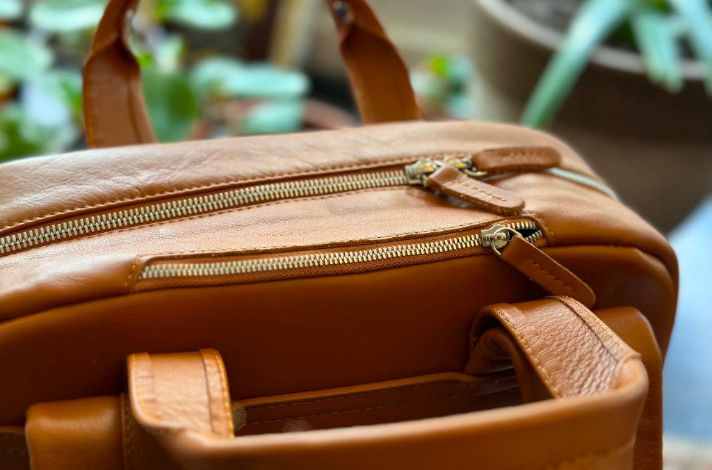 a piece of luggage sitting on top of a wooden chair