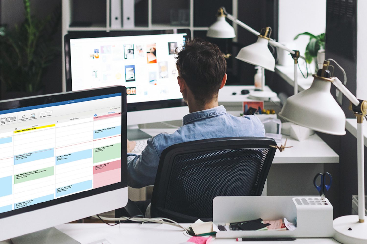 a man sitting at a desk in front of a computer screen