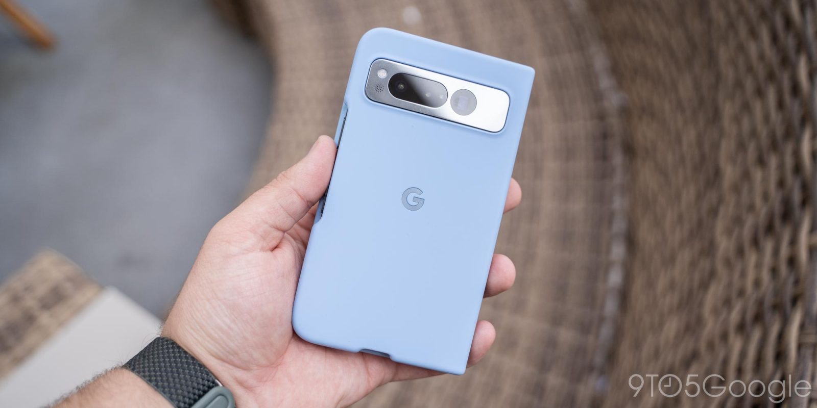 a hand holding a remote control