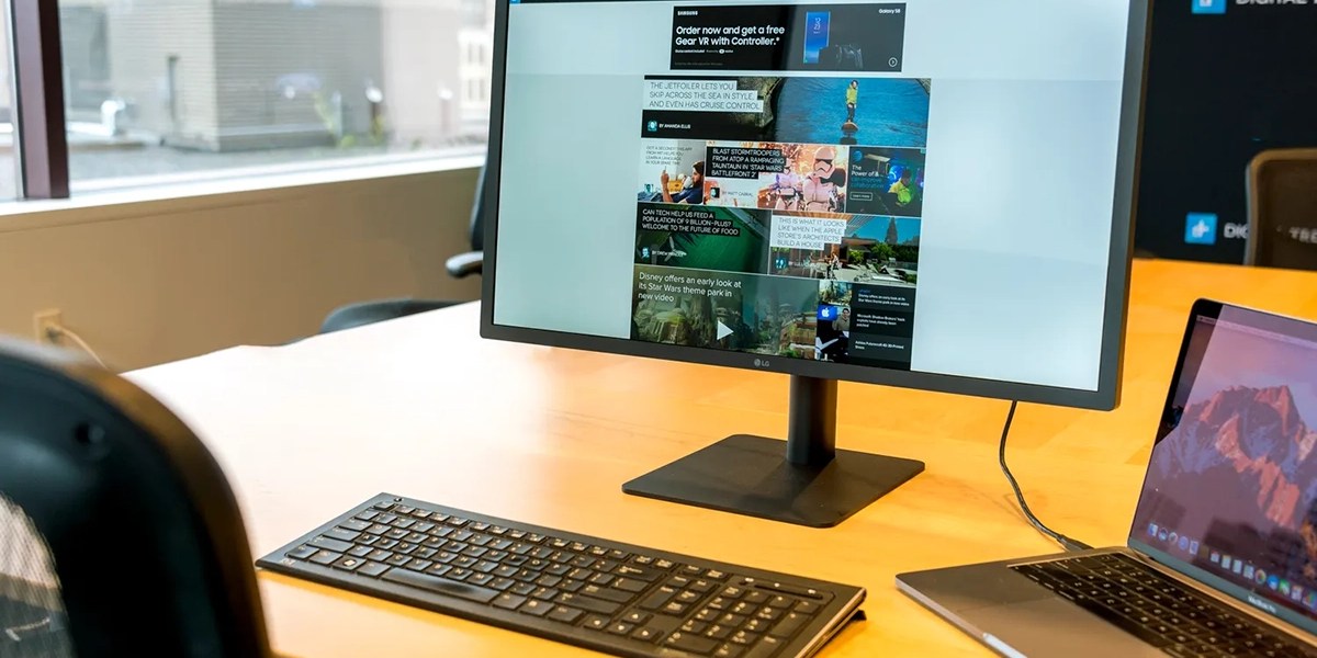 a desk with a laptop computer sitting on top of a table