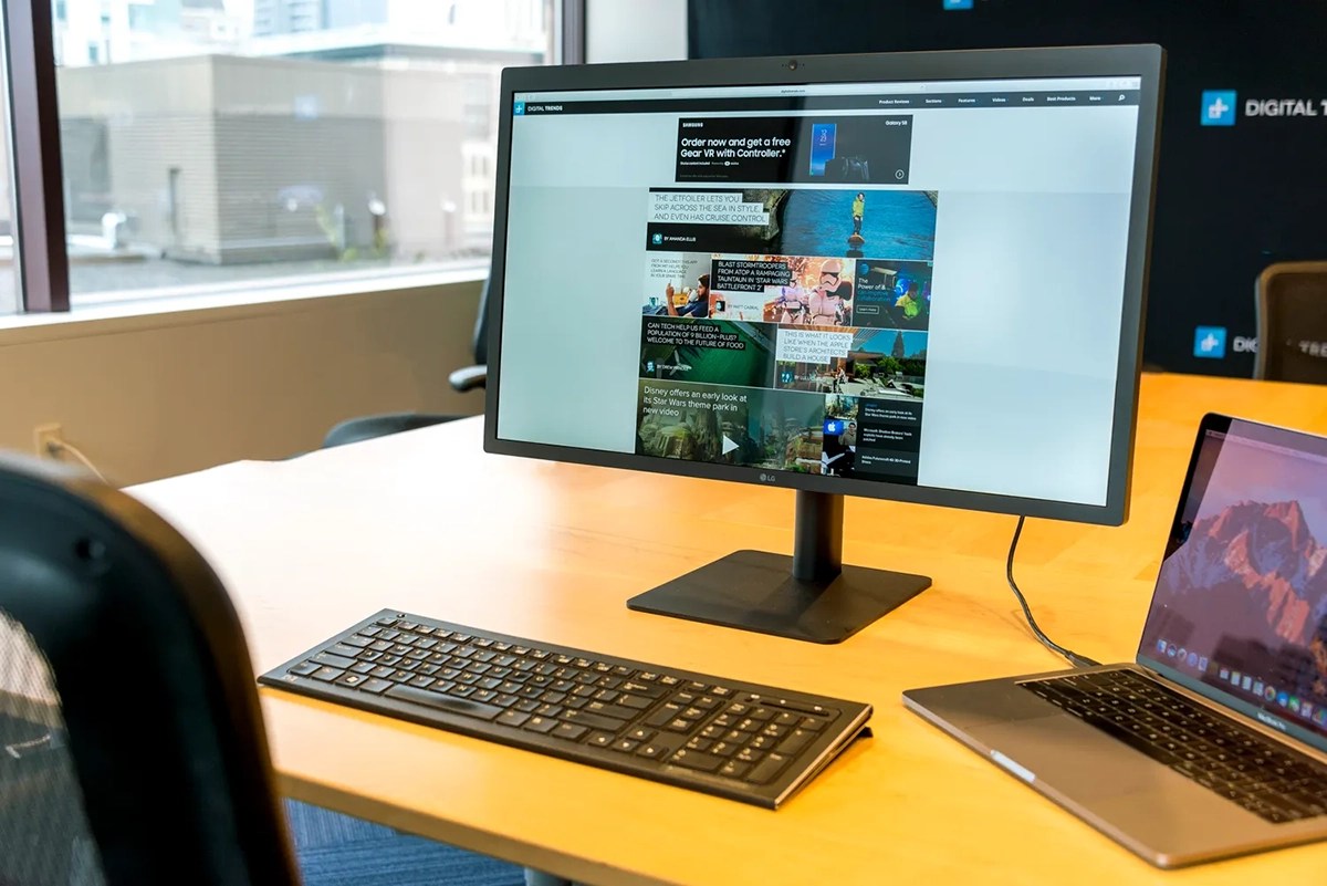 a desk with a laptop computer sitting on top of a table