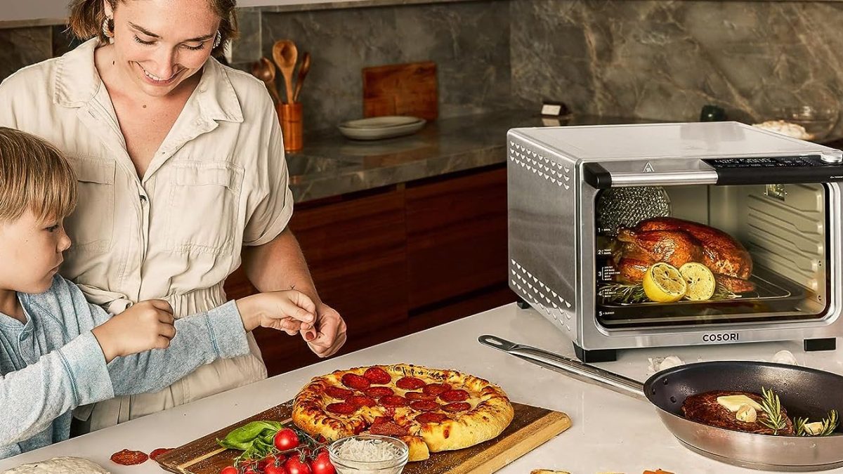 a person standing in front of a plate of pizza