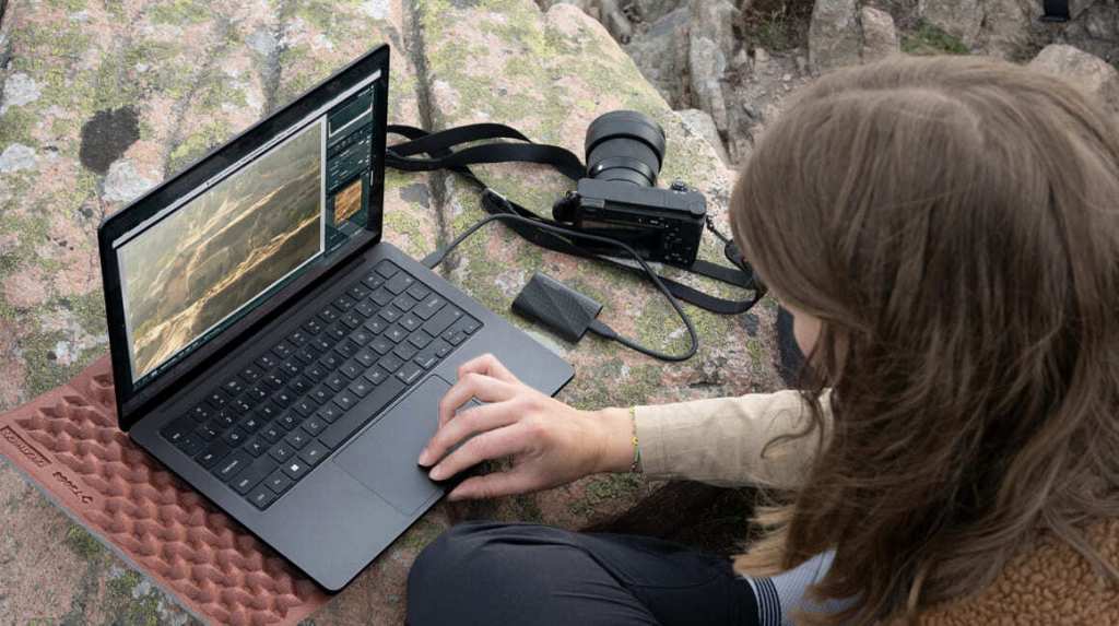 a person standing in front of a laptop