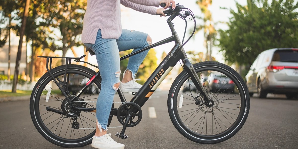 a woman riding on the back of a bicycle