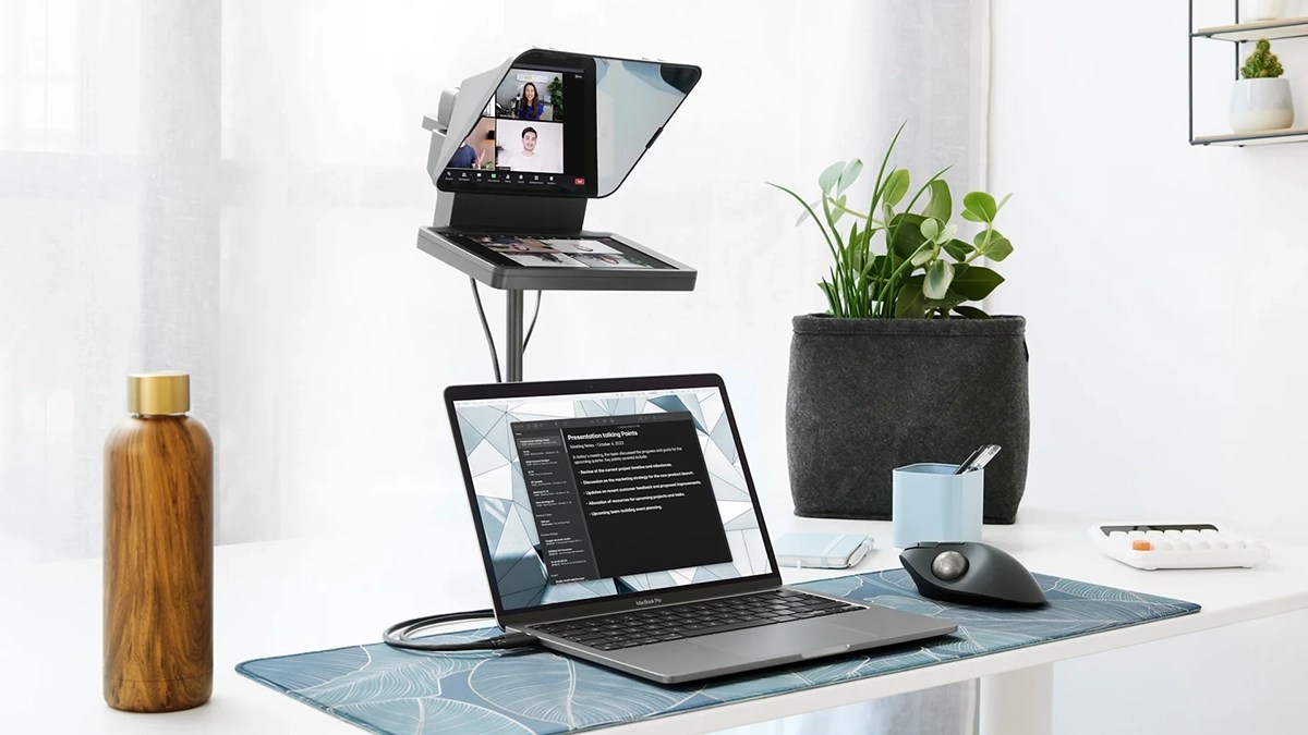 a desk with a laptop computer sitting on top of a table