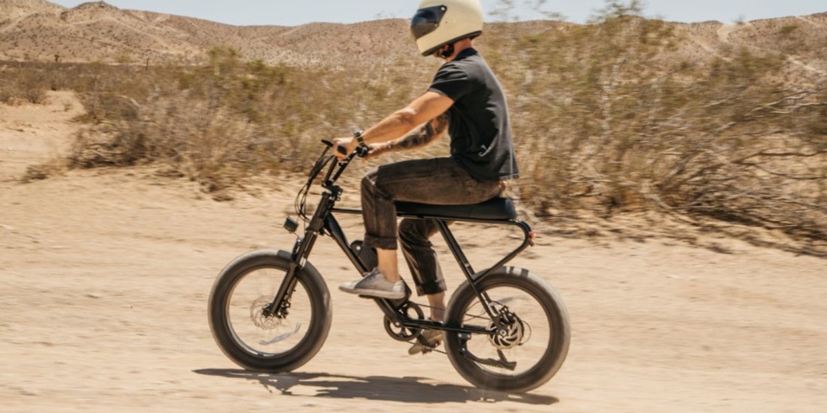 a man riding a bike down a dirt road