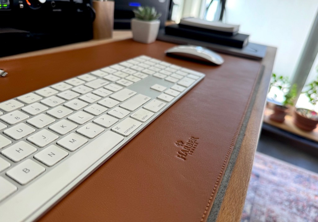 a close up of a laptop computer sitting on top of a wooden table