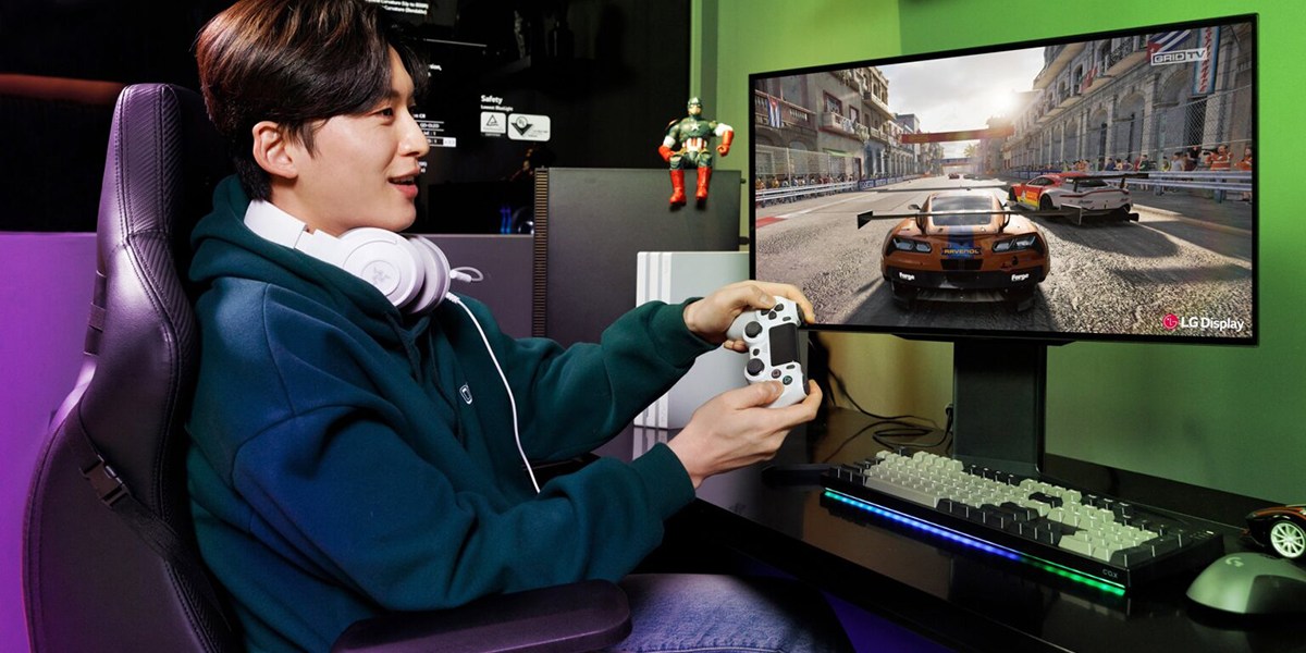 a person sitting at a desk in front of a computer