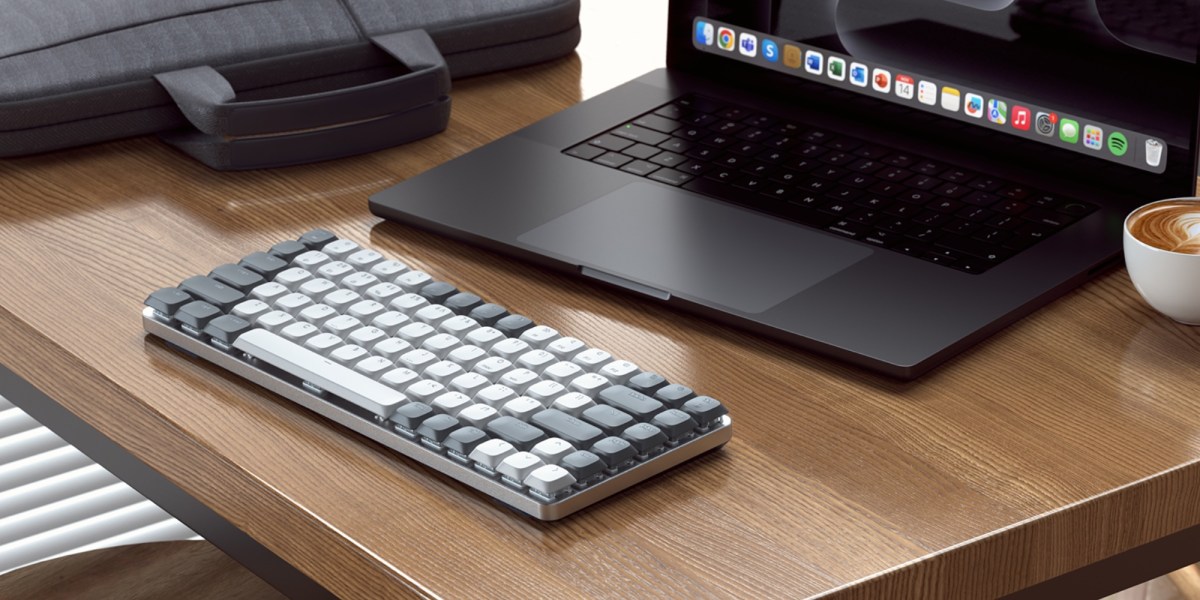 a laptop computer sitting on top of a wooden table