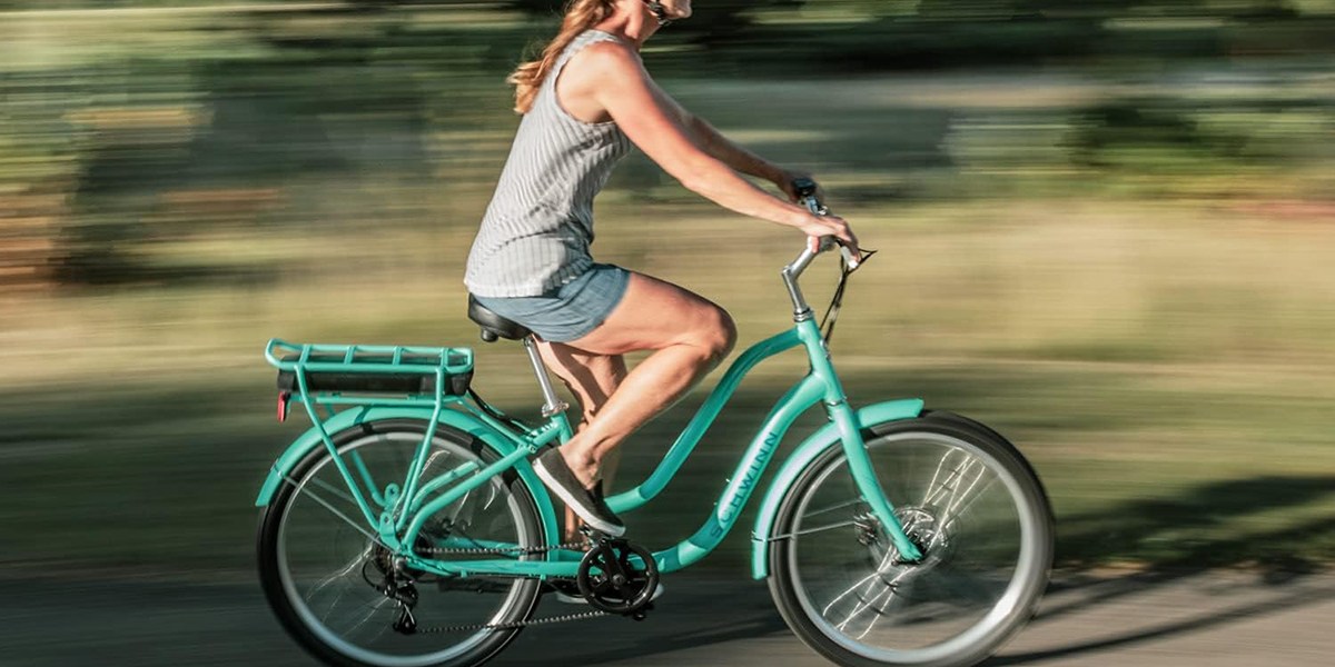 a person riding a bicycle down the street