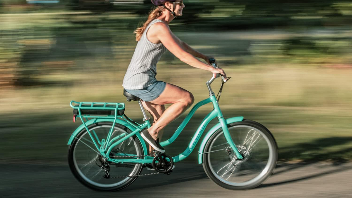 a person riding a bicycle down the street