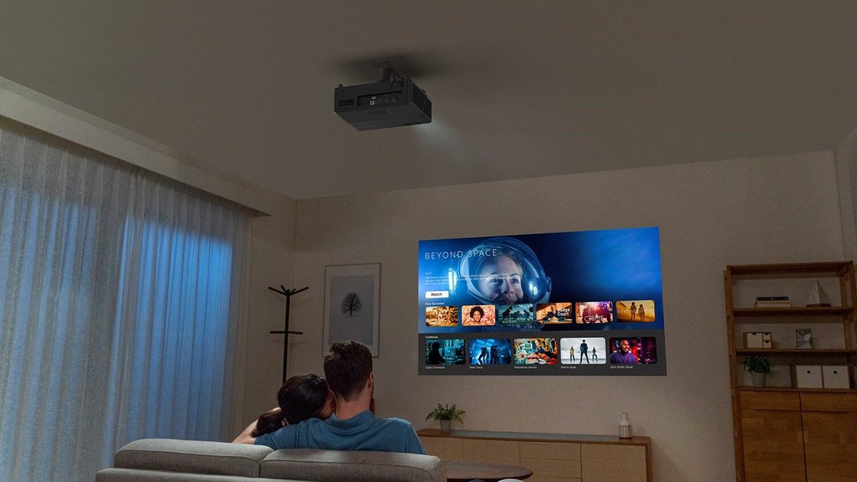 a man sitting in front of a television