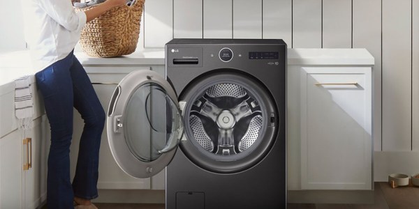 a person standing next to a washing machine