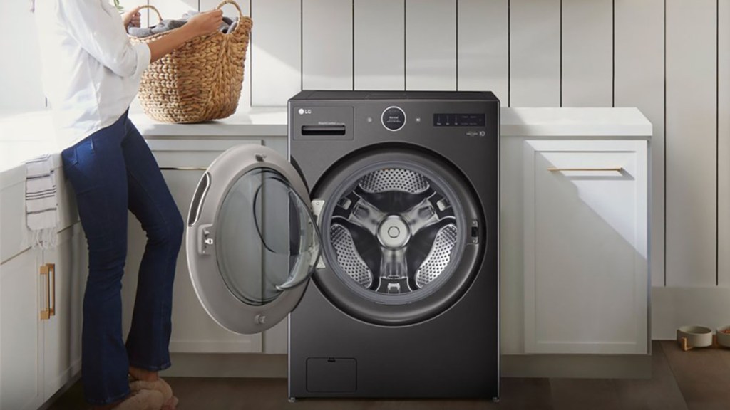 a person standing next to a washing machine