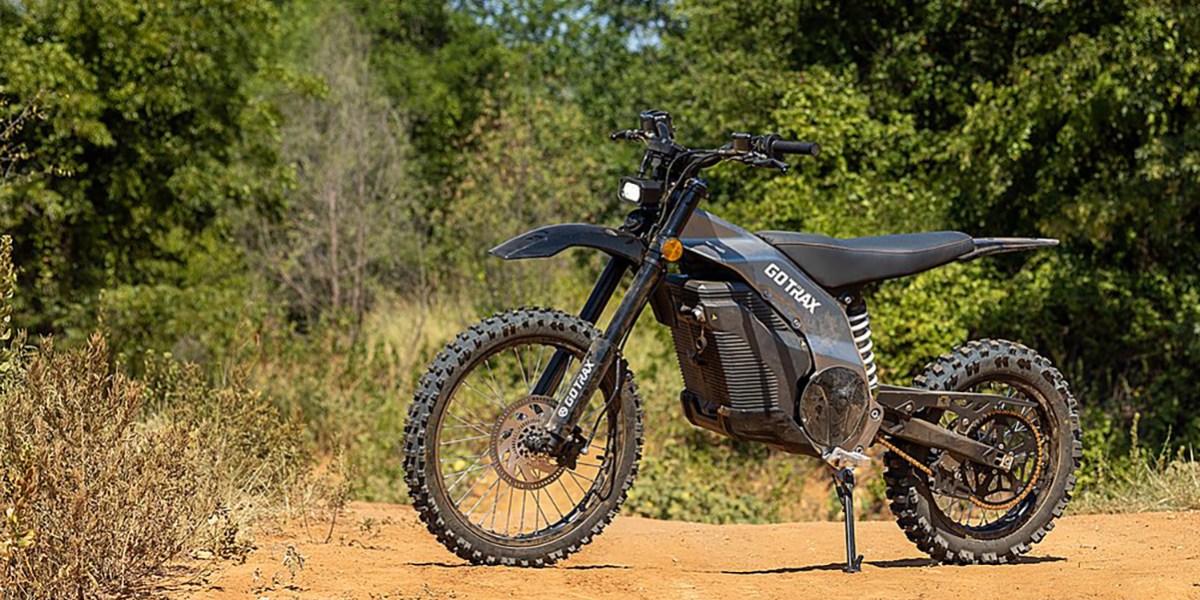 a motorcycle parked on a dirt road