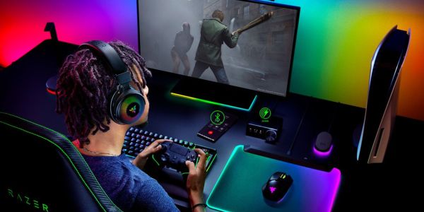 Image showing a person gaming in front of a monitor wearing Razer gaming peripherals.