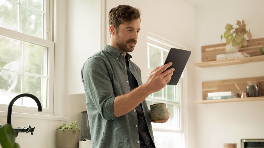 a man holding a tablet