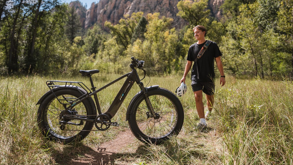 a man standing next to a bicycle