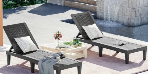 A lounge chairs and a table by a fountain