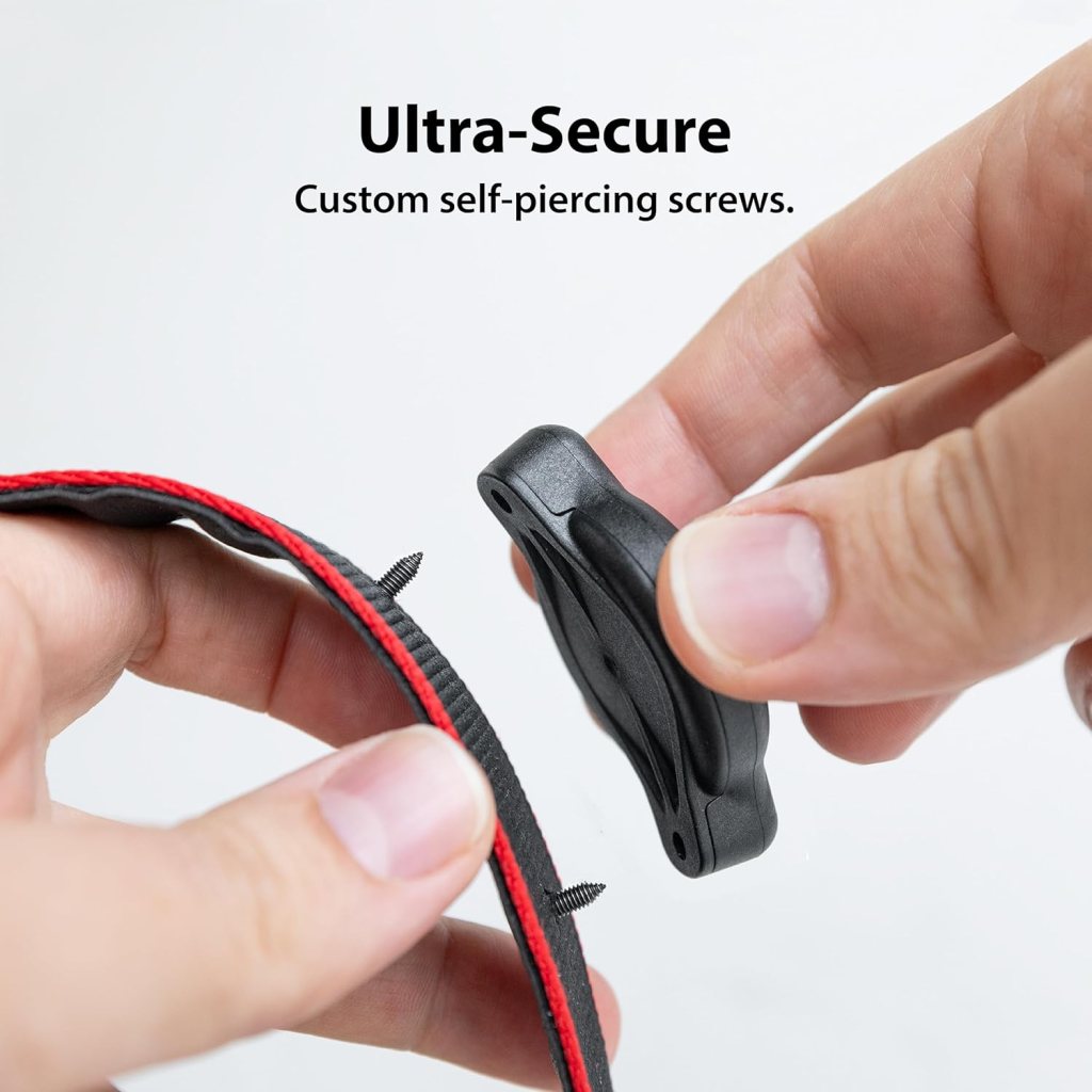 A close up of a hand holding a black and red strap