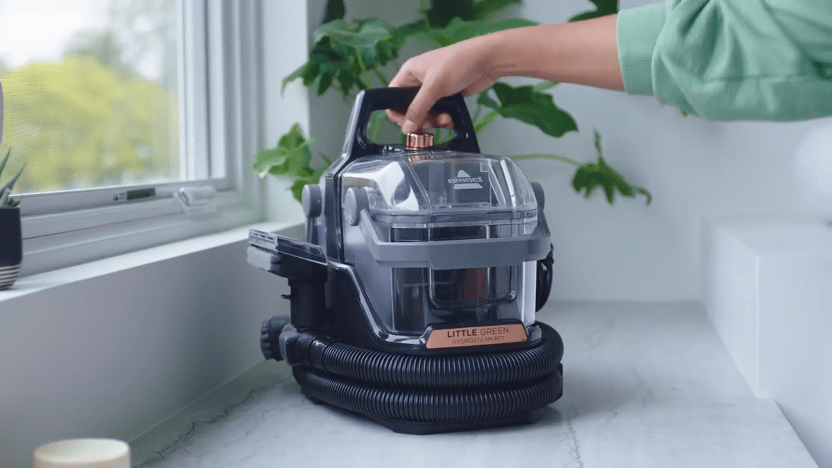 A person holding a vacuum cleaner