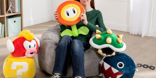 A woman sitting on a bean bag with a group of stuffed toys.