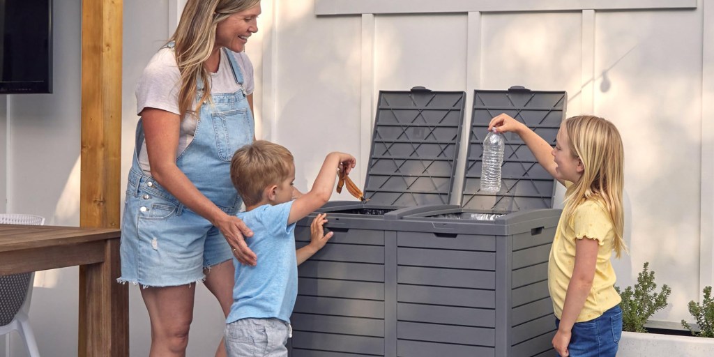 A woman and a boy throwing a trash can