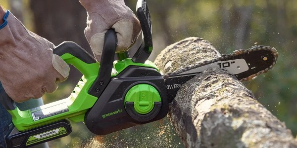 A hand holding a chainsaw