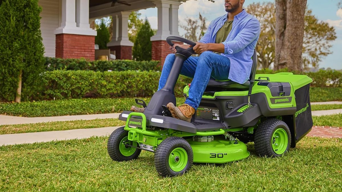A man sitting on a lawn mower