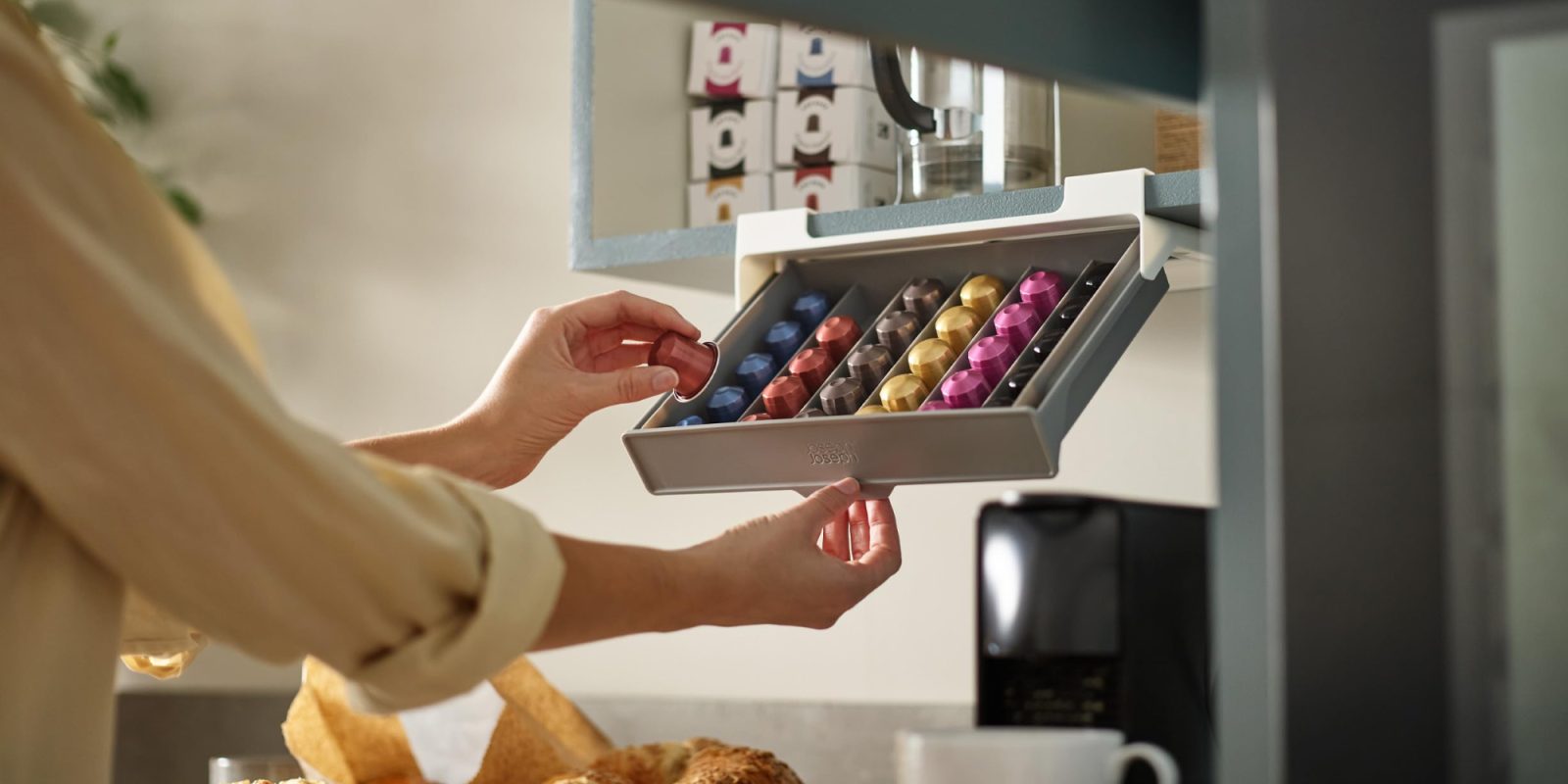 A person holding a capsule in a box