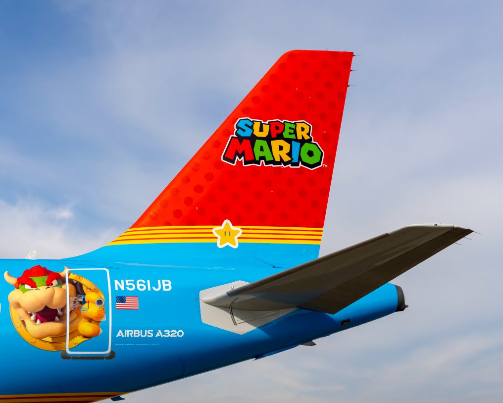 The tail of a plane with cartoon characters on it