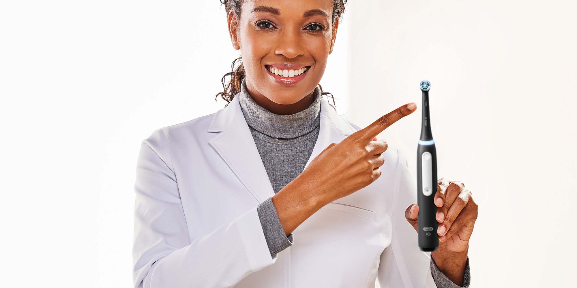 A woman pointing at a toothbrush