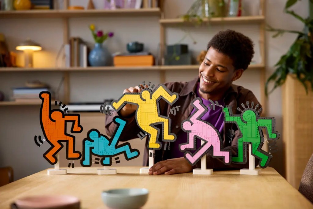 A man sitting at a table looking at colorful figures