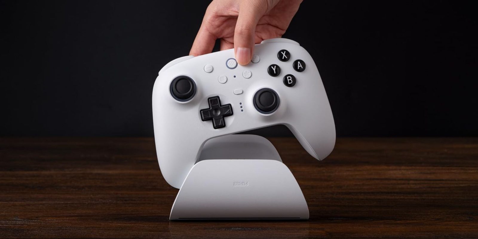 Image showing a person placing a controller on a charging dock.