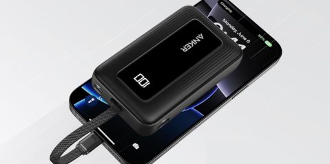 A black rectangular device with a cord attached to a cell phone