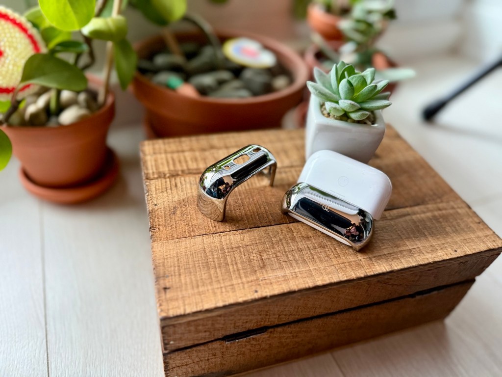 A small wooden box with a couple of metal objects on it
