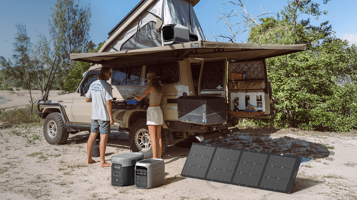 A man and woman standing next to a van