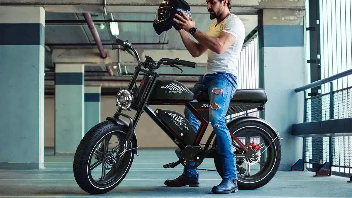 A man holding a helmet on a motorcycle